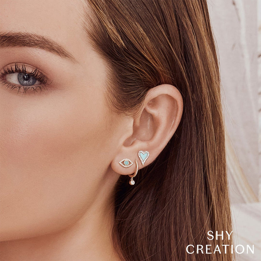 Shy Creation Diamond Huggie Earrings in 14 karat yellow gold with diamonds totaling 0.14 carats.