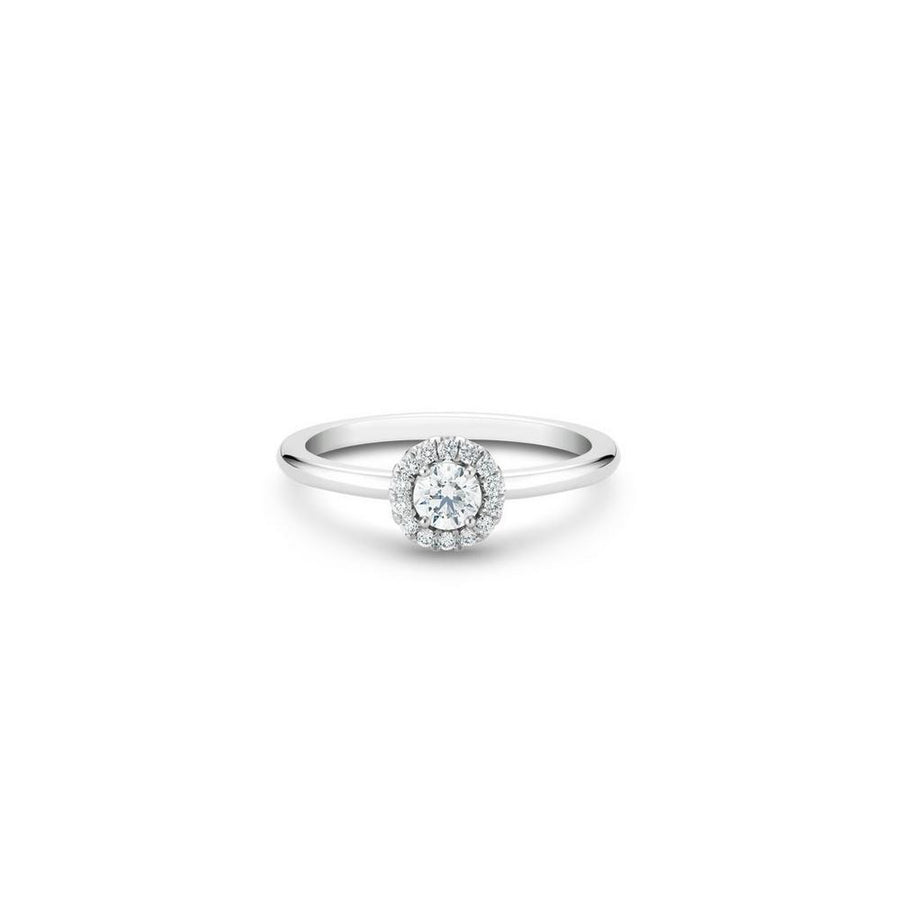 De Beers Aura Round Brilliant Diamond Ring in platinum. The ~0.20 carat round brilliant solitaire is surrounded by a halo of micropavé diamonds totalling ~0.10 carats.
