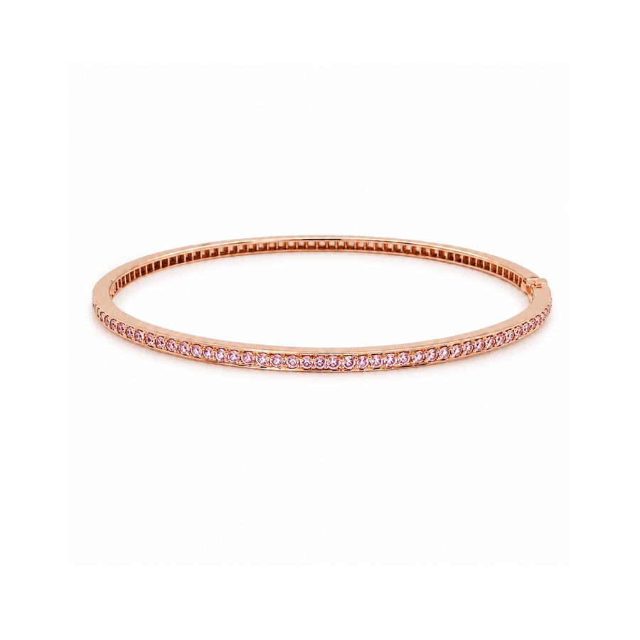 18K rose gold bangle bracelet featuring a single row of channel-set round pink sapphires