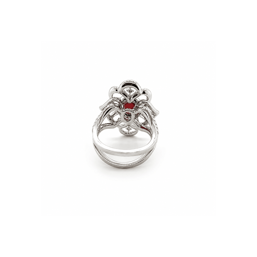 18K white gold ring featuring a center oval-cut ruby