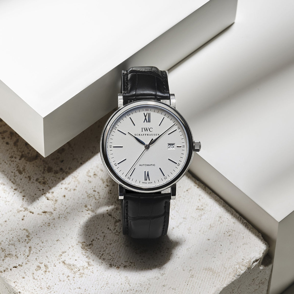 IWC Schaffhausen Portofino Automatic in a 40mm stainless steel case with silver dial on leather strap, featuring a date display and automatic movement.
