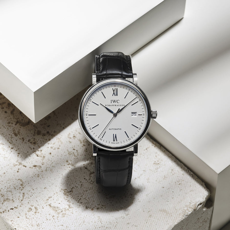 IWC Schaffhausen Portofino Automatic in a 40mm stainless steel case with silver dial on leather strap, featuring a date display and automatic movement.