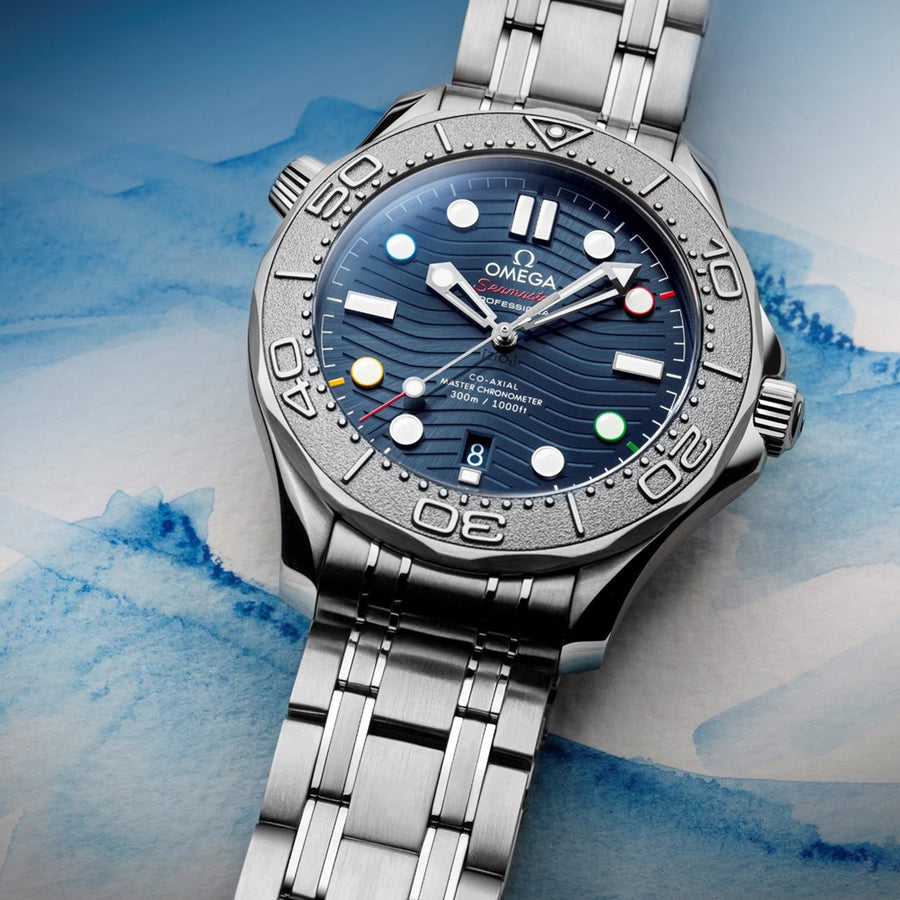 Omega Seamaster Diver 300 Co-Axial Master Chronometer "Beijing Olympics 2022" Special Edition in a 42mm stainless steel/titanium case with blue dial on stainless steel bracelet, featuring a date display and automatic movement.