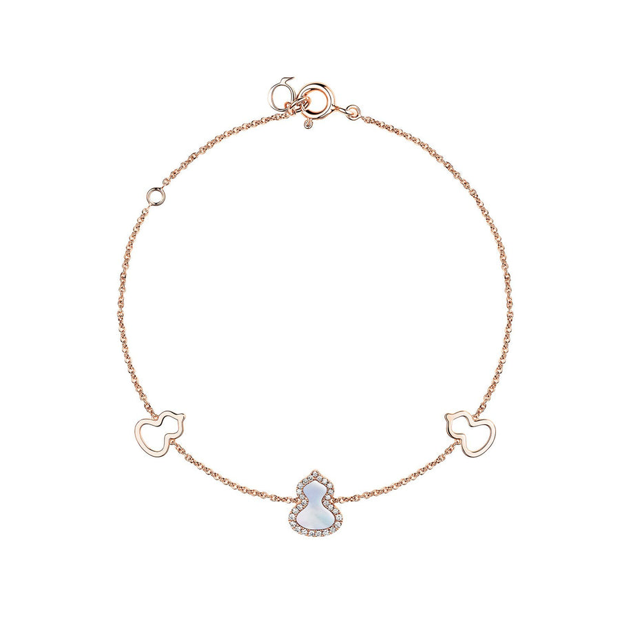 Qeelin Petite Wulu Bracelet in 18 karat rose gold with one mother-of-pearl and diamond wulu in the center and two gold wulu on each side.