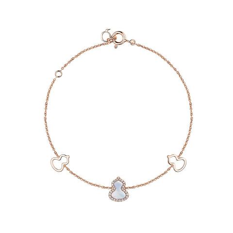 Qeelin Petite Wulu Bracelet in 18 karat rose gold with one mother-of-pearl and diamond wulu in the center and two gold wulu on each side.