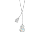 18 karat white gold with one mother-of-pearl and diamond wulu pendant and one pave diamond wulu pendant necklace.