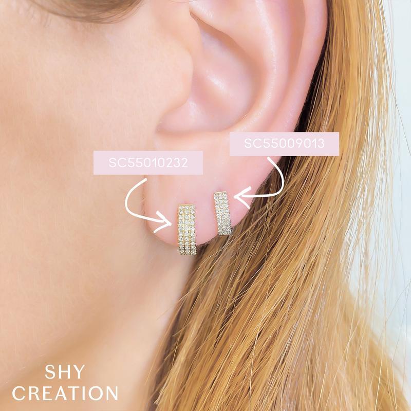 Shy Creation Mini Huggie Earrings in 14 karat yellow gold with diamonds totaling 0.17 carats.