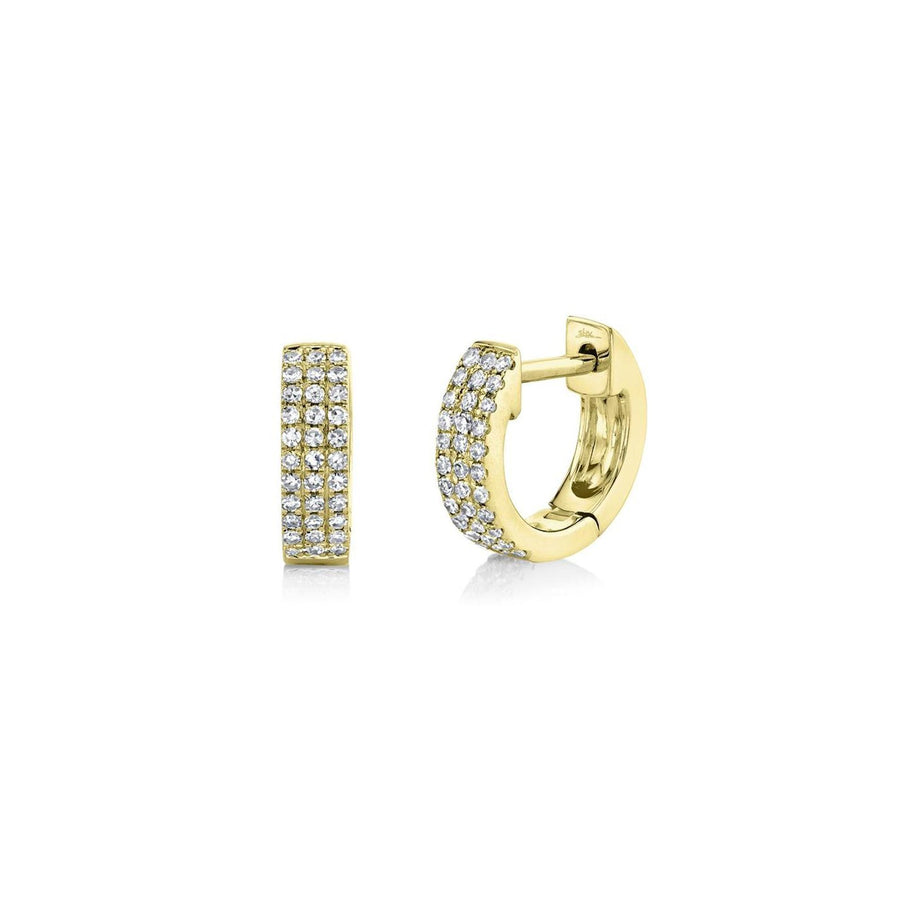 Shy Creation Mini Huggie Earrings in 14 karat yellow gold with diamonds totaling 0.17 carats.