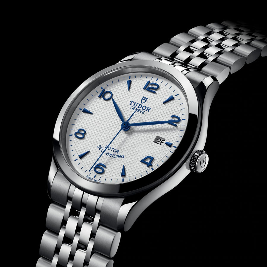 TUDOR 1926 in a 39mm stainless steel case with silver dial on stainless steel bracelet, featuring a date display and automatic movement.