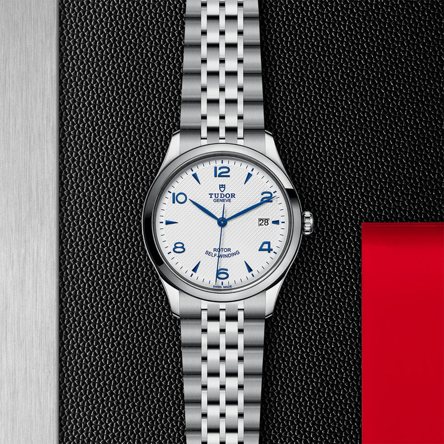 TUDOR 1926 in a 39mm stainless steel case with silver dial on stainless steel bracelet, featuring a date display and automatic movement.