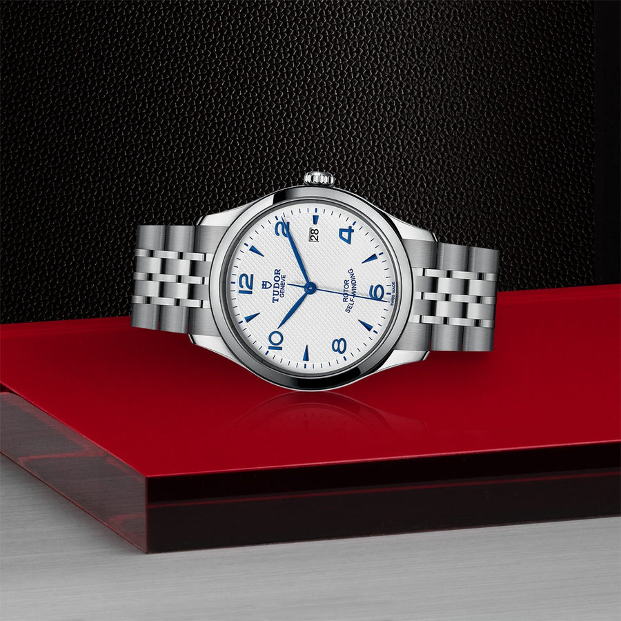 TUDOR 1926 in a 39mm stainless steel case with silver dial on stainless steel bracelet, featuring a date display and automatic movement.
